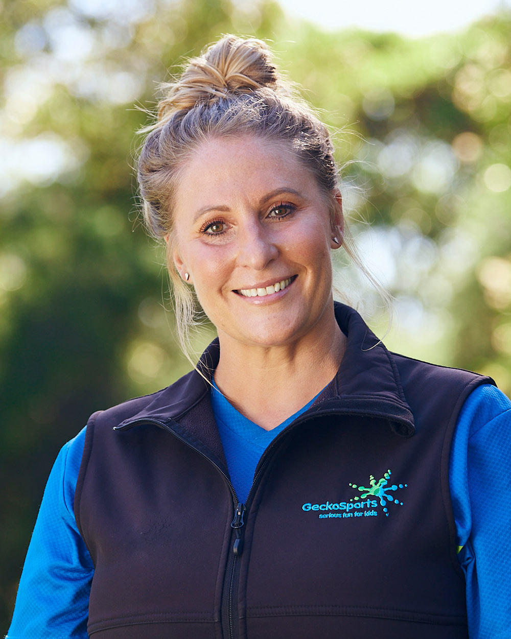 Portrait of Kim O’Donnell, GeckoSports owner and franchisor, smiling outdoors in uniform.