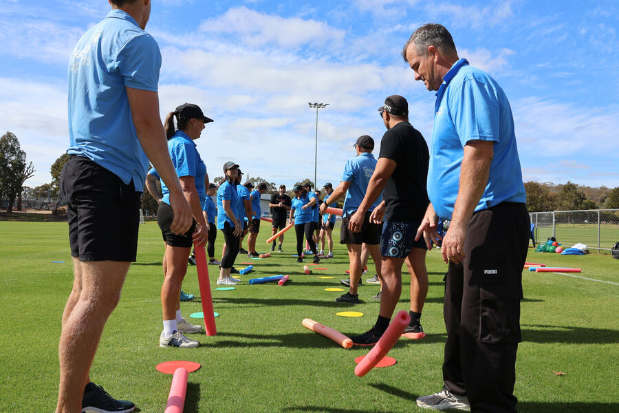 Group of GeckoSports coaches doing a team building activity outdoors